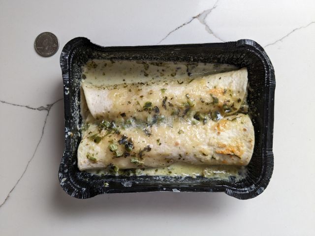 A tray of Cross-section of Real Good Foods Creamy Poblano Chicken Enchiladas.