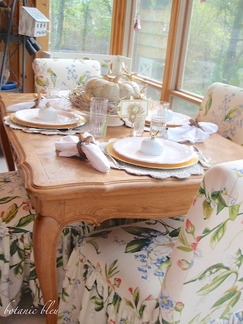 Thanksgiving gold and white table setting on an antique French wood carved table