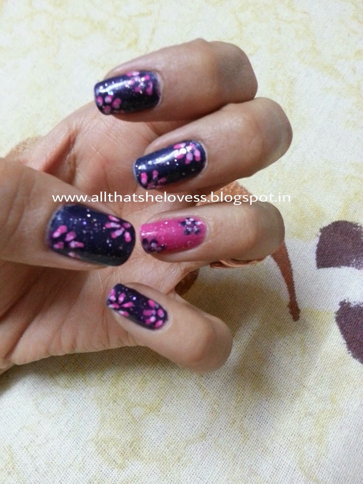 All that she lovess: Floral nail art design with an accent