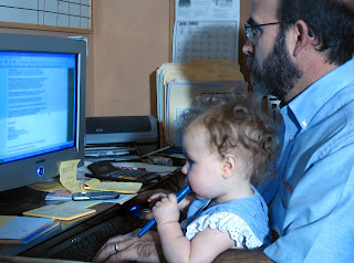 father and child viewing computer screen
