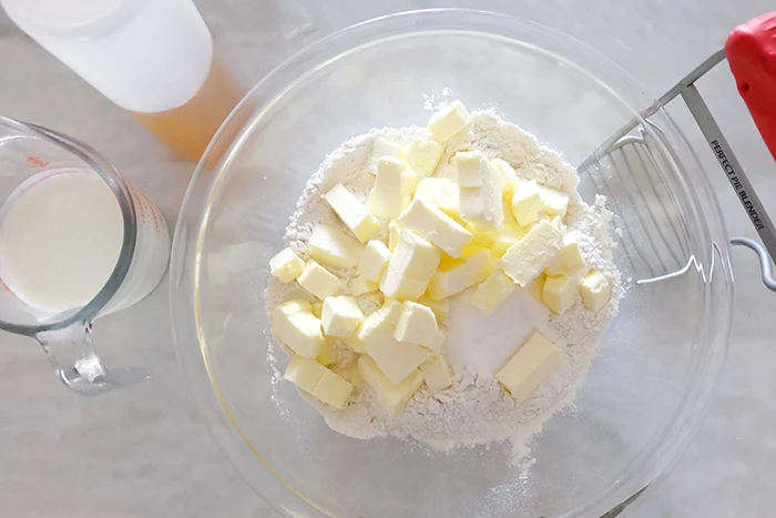 adding butter cubes to dry ingredients