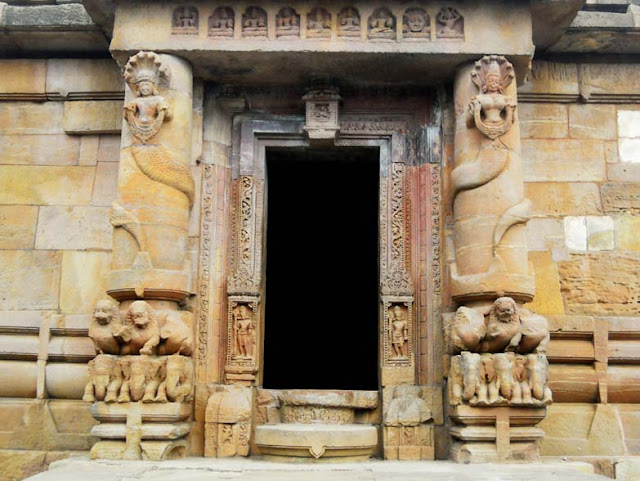 The temple entrance, flanked by round columns entwined by a naga and nagin, at the Rajarani Temple, Bhubaneshwar