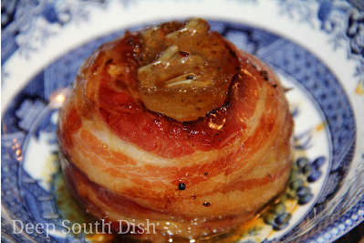 Sweet Vidalia onions, stuffed with garlic and butter and drizzled with balsamic vinegar, wrapped in bacon and placed in individual packets to be cooked on the grill or oven.