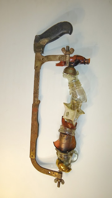 saw handle with glass, bone, found objects
