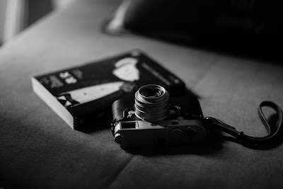 camera on table beside book