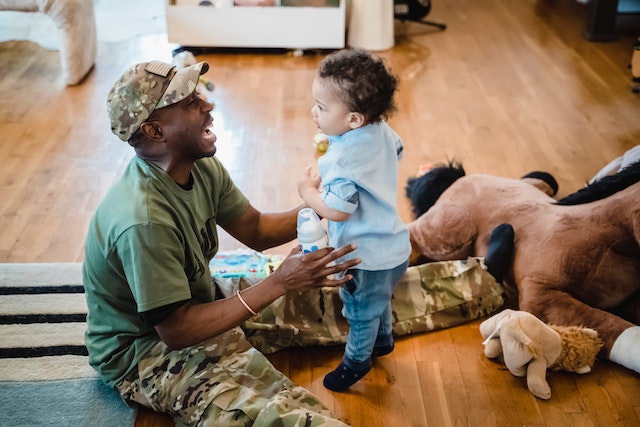 a military dad playing with his son