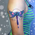 Colorful dragonfly tattoo on a girl's arm