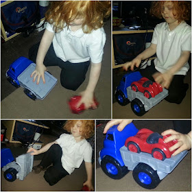 4 year old brumming with his cars on the carpet