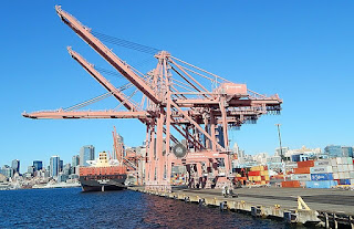 Port of Seattle cranes by Ron Clausen on Wikimedia Commons - https://commons.wikimedia.org/wiki/File:Port_of_Seattle_cranes_on_a_sunny_October_day.jpg