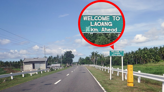 a kilometer marker and signboard indicating distance to Laoang Northern Samar