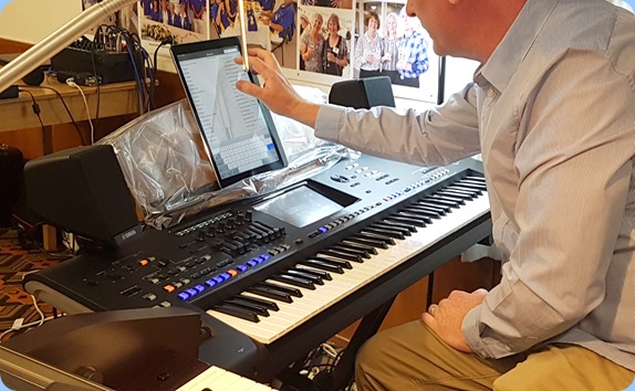 Darren Smith setting up to play the latest Yamaha arranger keyboard, the Genos. Darren uses an iPad for his music notation/chords/song notes.