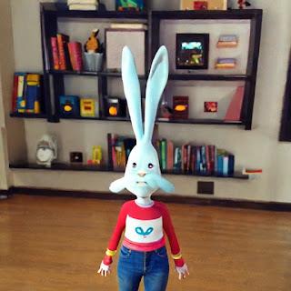 A thin rabbit in front of bookshelves