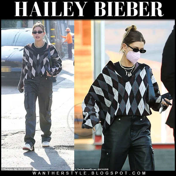 Hailey Bieber in grey argyle sweater and black leather pants