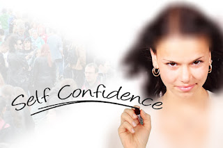 Woman with brown hair confidently writing "Self Confidence"