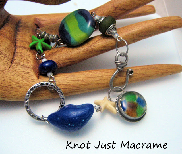 Bracelet using Windbent polymer clay bird, sea glass and resin clasp, Kazuri bead, lampwork spacers and dyed howlite starfish.