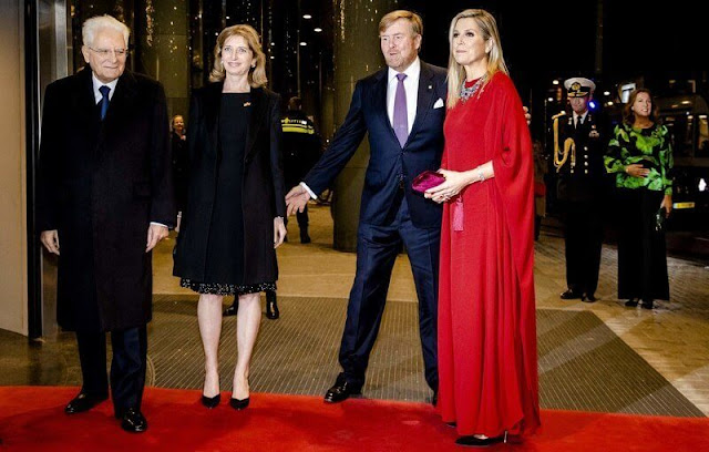 Queen Maxima wore a red silk cape kaftan dress by Valentino. multi stone gold diamond necklace. Gianvito Rossi suede pumps
