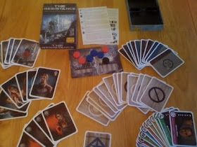 The Resistance card game components laid out before play
