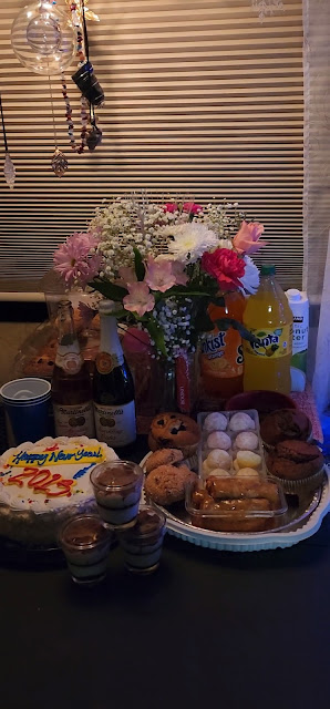 Small Table with food and drinks and Flowers