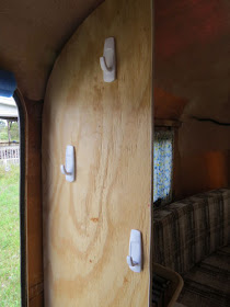 wall with hooks in a partially finished fiberglass trailer