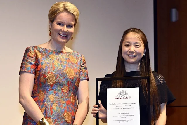 Queen Mathilde wore a printed knee-length short sleeve midi dress by Etro. Baillet Latour Biomedical Award 2024. Dr Jingjing Zhu