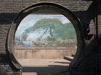 Looking through the brick wall to a mural