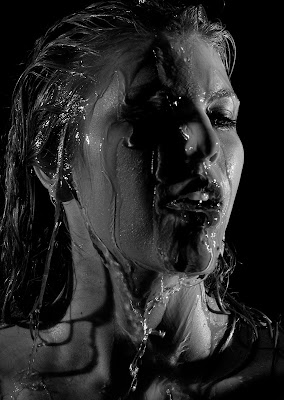 Water pouring on woman at boudoir shoot