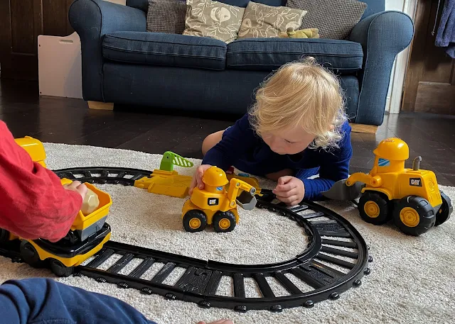 Two children playing with the Junior Crew train set and Construction Buddy