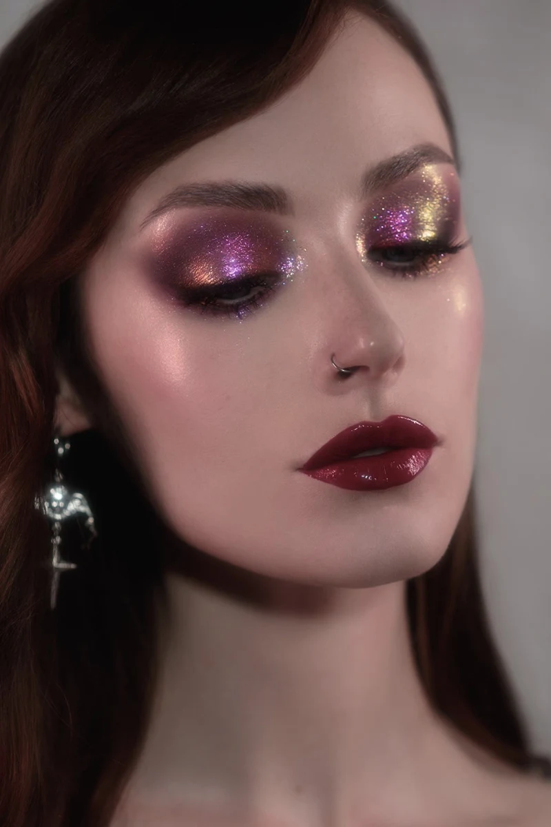 portrait of a beautiful woman with a dark feminine makeup look, bold lipstick and eyeshadow