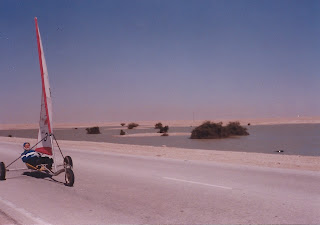 Sand yacht races in Qatar, with temporary lake in background