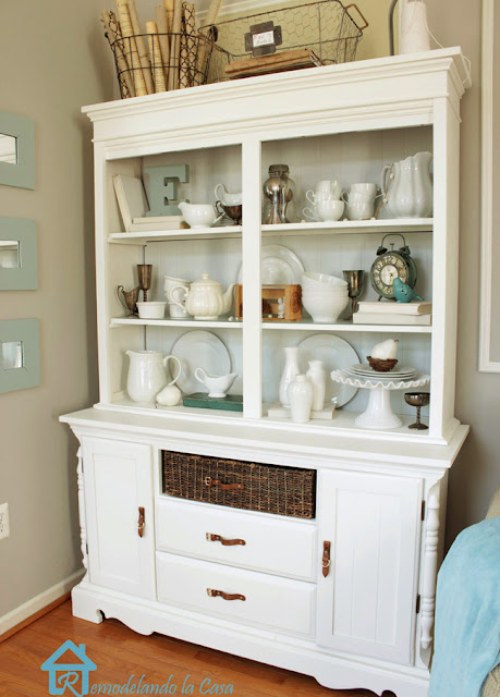 a dark hutch is transformed with moldings and white paint.