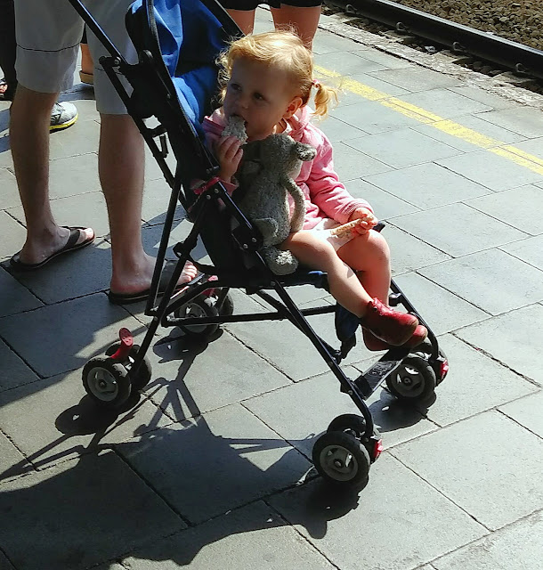 a european kid in stroller at Brussels Midi