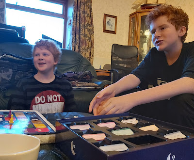 Two teenagers playing family quiz night game