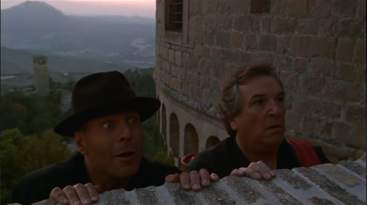 This is a picture of Hudson Hawk Bruce Willis hanging off the side of 