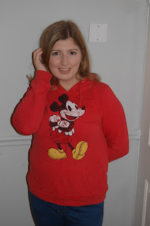 Meagan wearing a red hoodie with an image of the classic Mickey Mouse on it