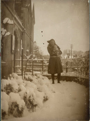 Girl with white cat in snow