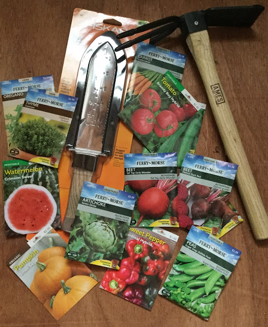 A pile of seeds with some gardening tools