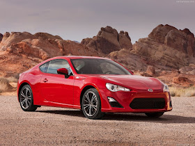 Front three-quarters view of Red 2013 Scion FR-S in desert setting