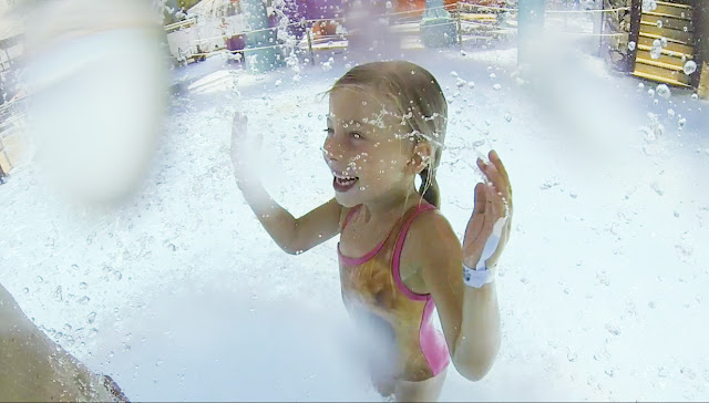 Little girl splashes in the water at Adventure Landing's Shipwreck Island