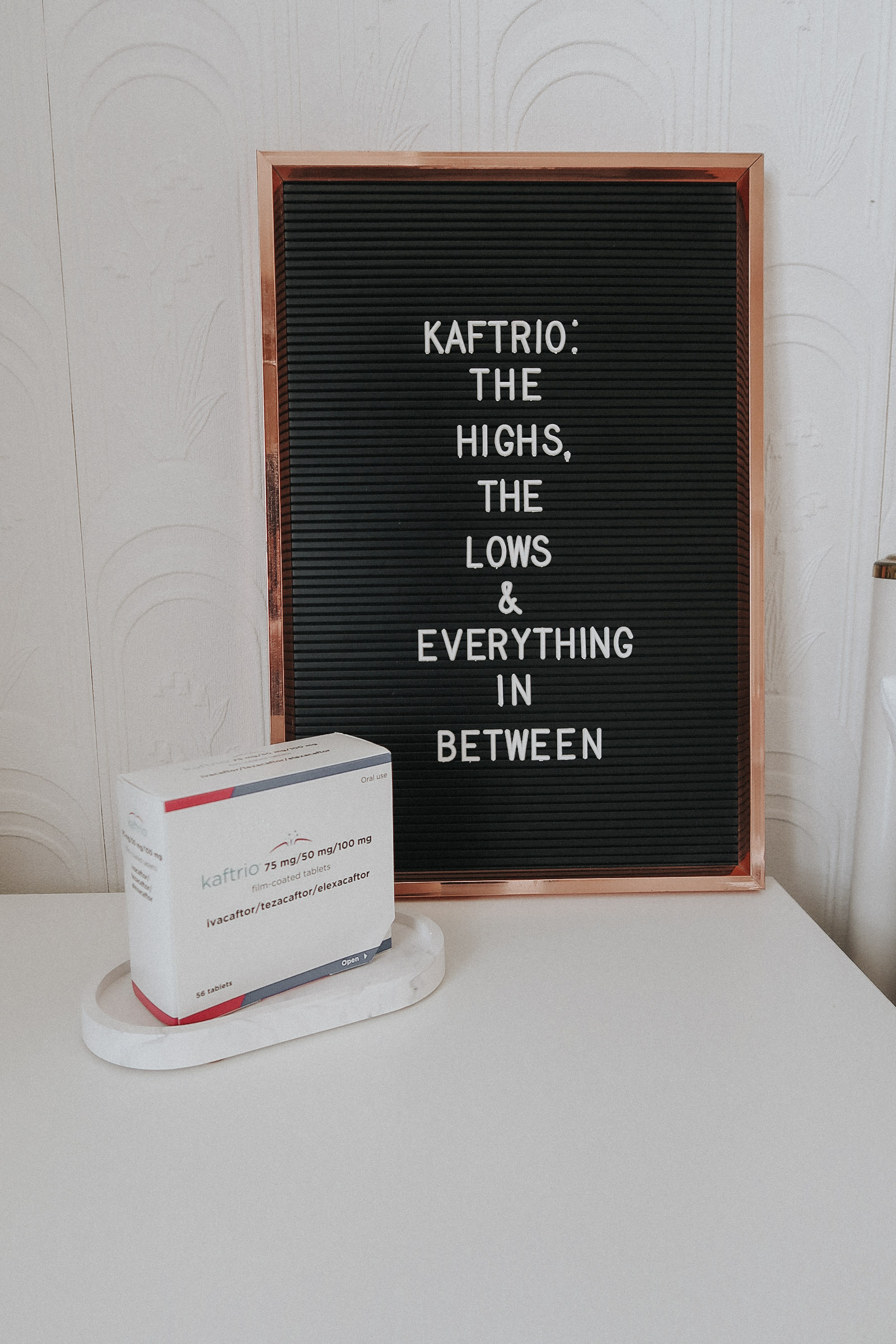 A box of Kaftrio next to a retro letter board.