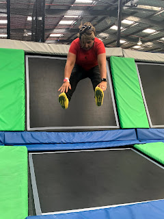 woman in mid air doing a trampoline jump