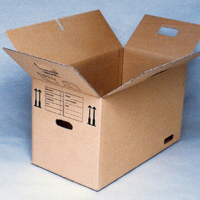 A cardboard box sitting at an angle with top lids standing open.