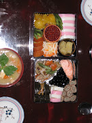 New Year's Osechi in the two boxes, along with Ozōni a Japanese soup with .