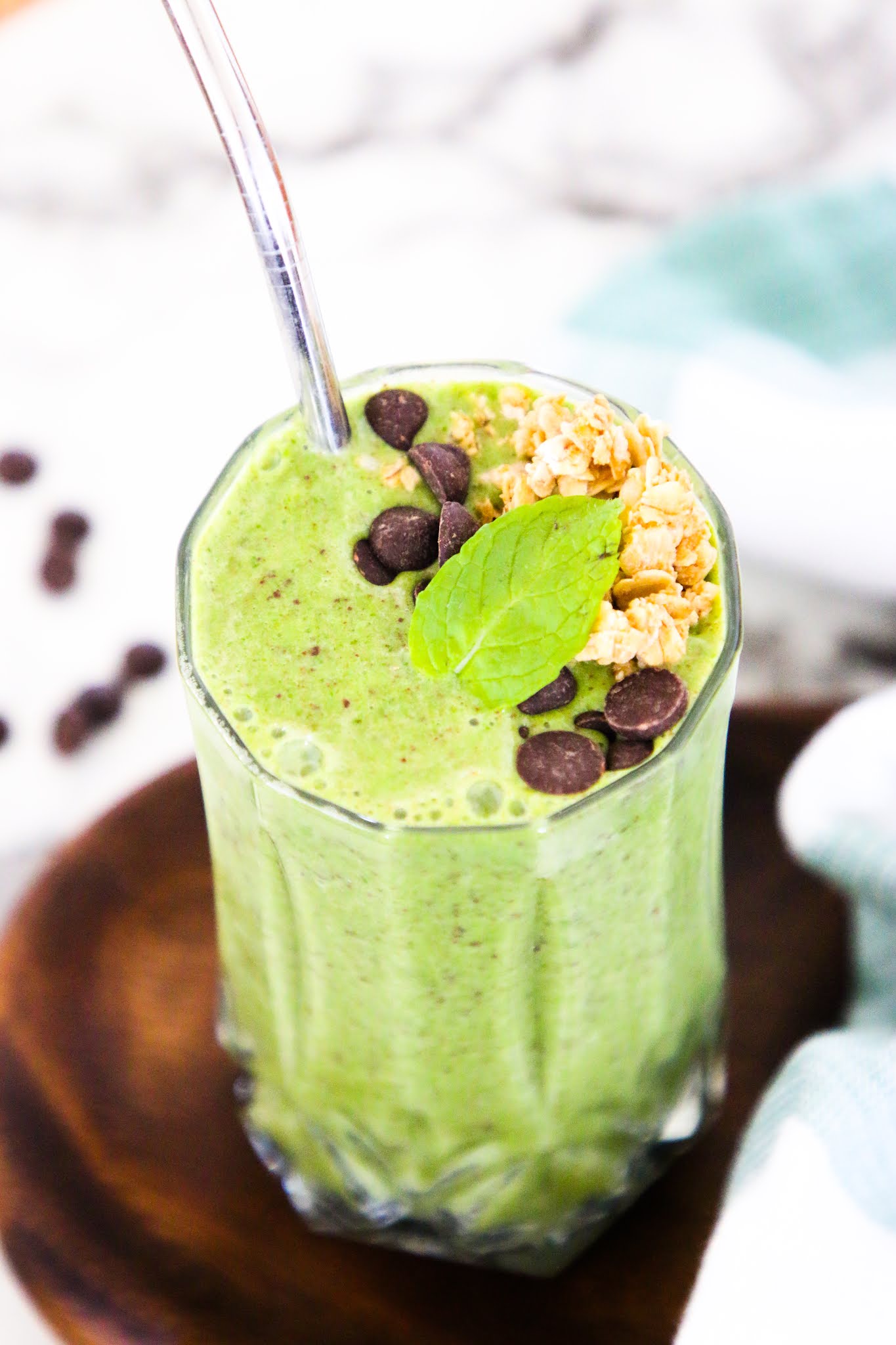 Health shamrock shake smoothie on a marble table top with a metal straw.