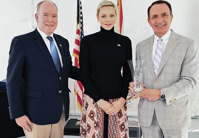 Princess Charlene wore a diamonds printed skirt by Longchamp Paris. Fort Lauderdale Aquatic Centre in Florida