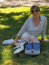 White shorts pared with sneakers, a blouse and vintage Pierre Cardin scarf, Furla hand bag