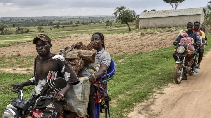 Residents transport their belongings as they flee on motorcycles towards Mangu, near Jos in the Plateau State in Nigeria, on May 20, 2023 escaping unrest in central Nigeria