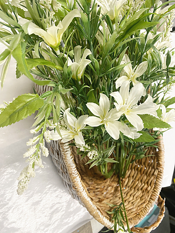 basket with white flowers spilling over one side