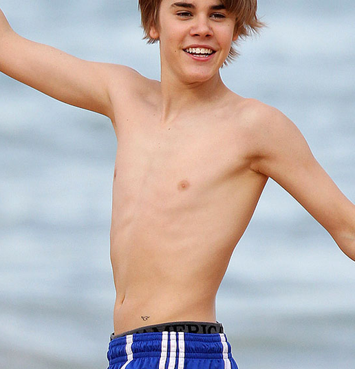 bieber on the beach. whats justin ieber tattoo.