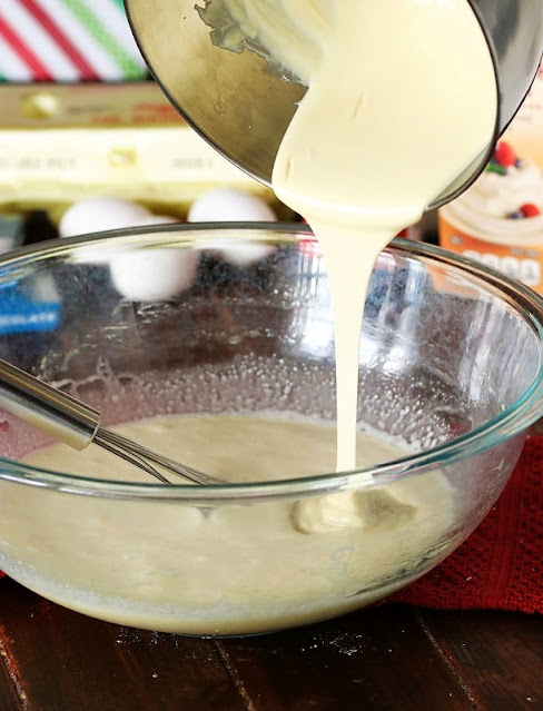 Pouring Melted White Chocolate Into Creme Brulee Mixture Image