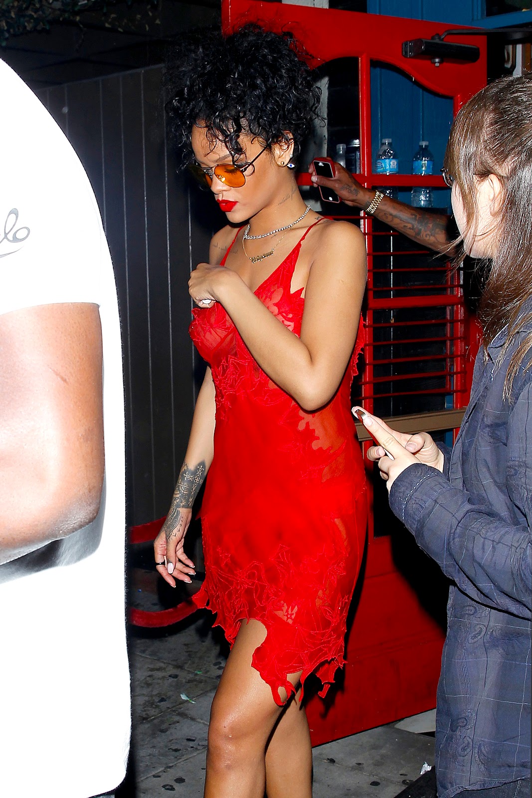 Rihanna in see-through red scarlet dress while nightclubbing in West Hollywood.